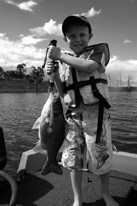Hayden Medcalf with a bass taken on a Halco Scorpion in Monduran while chasing barra.